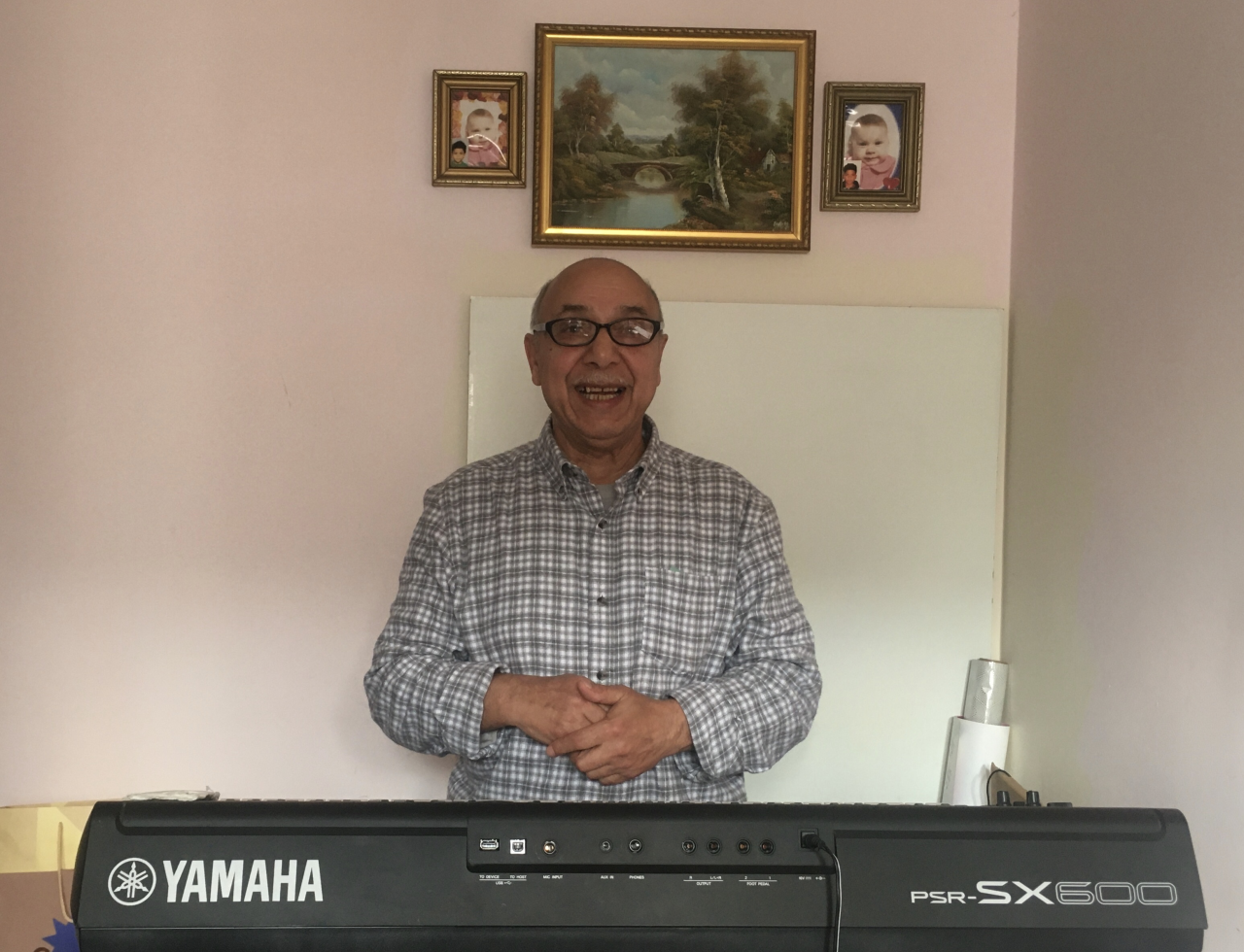 Figure 2. Pēteris Leimanis at home with his synthesizer during a recording session of worship songs on August 26, 2023 (photograph by Ieva Weaver; the photo is used by permission of Pēteris Leimanis).