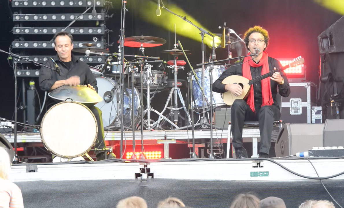 Figure 6. Salah Ammo (right) and Peter Gabis (left) at the concert Voice for Refugees, October 5, Vienna, Austria (still by the author from a YouTube video created by Schwaiger 2015).