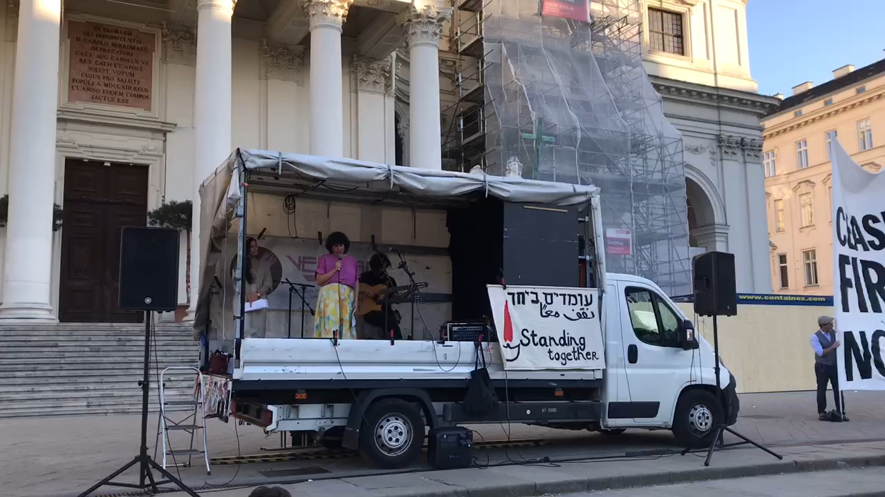 Figure 5. Golnar Shahyar and Mahan Mirarab performing at the rally of Standing Together Vienna on April 7, 2024, at Karlsplatz, Vienna (photo by Isabel Frey).